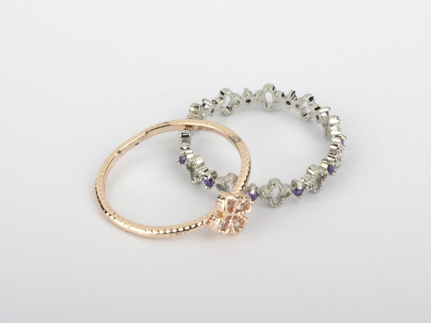 One Golden Ring set with Clear Crystals and one Silvery Ring set with Clear and Purple Crystals