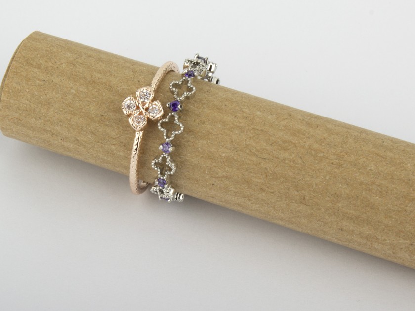 One Golden Ring set with Clear Crystals and one Silvery Ring set with Clear and Purple Crystals