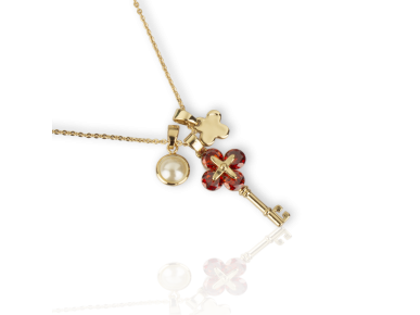Colgante compuesto por tres colgantes: una falsa perla, una llave dorada engastada con cristales rojos y una cruz dorada