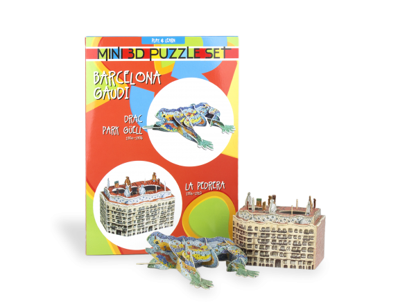A 3D puzzle of La Pedrera and a 3D puzzle of the Dragon of Park Güell, both assembled in front of the packaging
