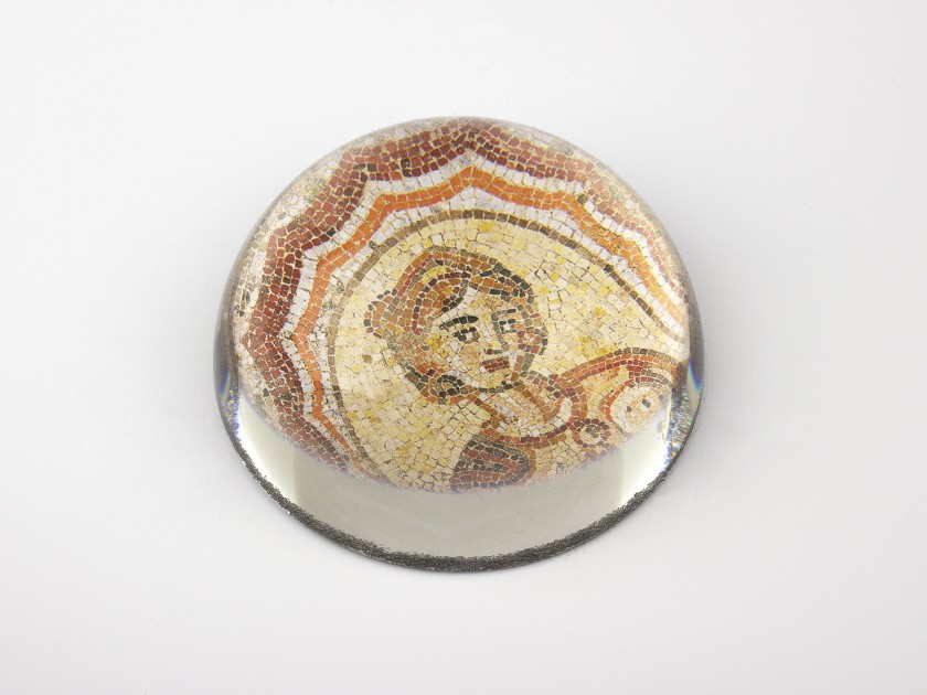 glass paperweight seen from above showing a detail of the Dotô mosaic reproduced inside