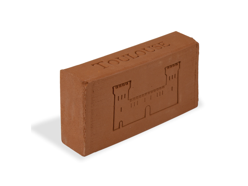 brick laid on edge with a silhouette of the Castelet engraved on one side of the brick