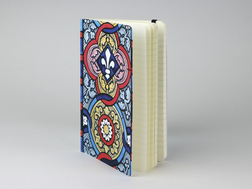 notebook seen from the front showing a cover printed with a stained glass pattern