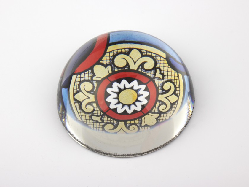 glass paperweight seen from above with a stained glass pattern inside