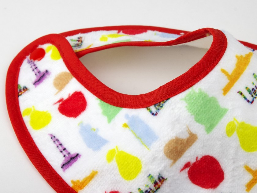 baby bib with different symbols of Catalan culture printed on it