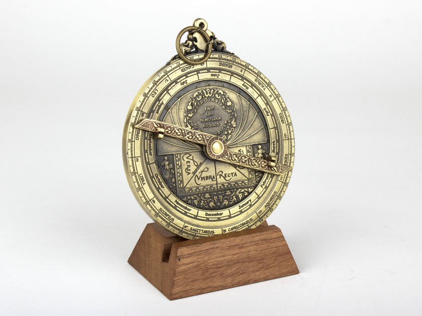Planispheric astrolabe in gilded metal on a wooden base