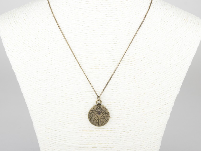 small gold-plated sundial-shaped pendant