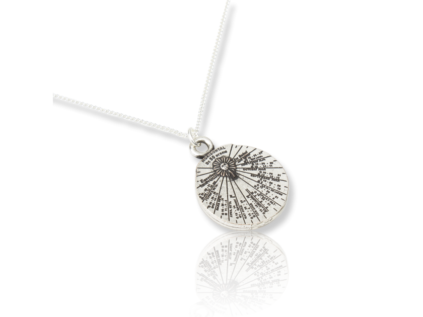 small silver-plated sundial-shaped pendant