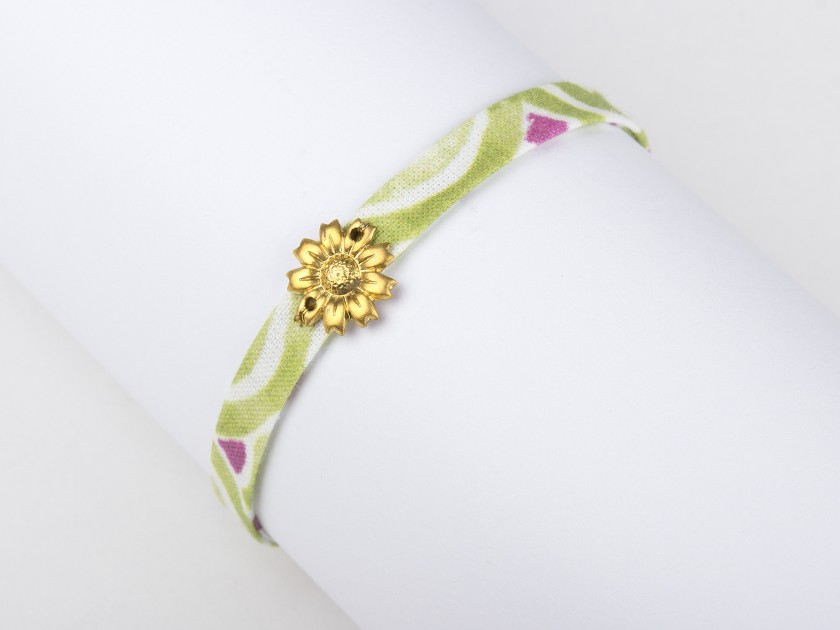 fabric bracelet in green tones with a golden sunflower sewn in