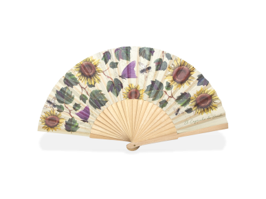 unfolded fan showing a wooden frame and a fabric printed with flowers and sunflower leaves