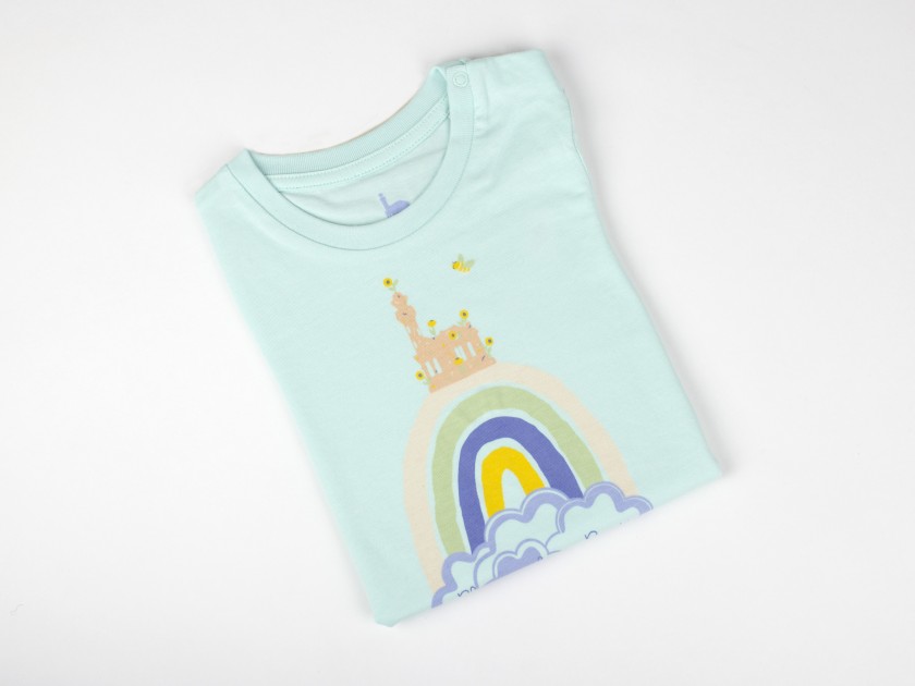 Little mint green water coloured t-shirt with a child's drawing and the name El Capricho de Gaudí printed on it