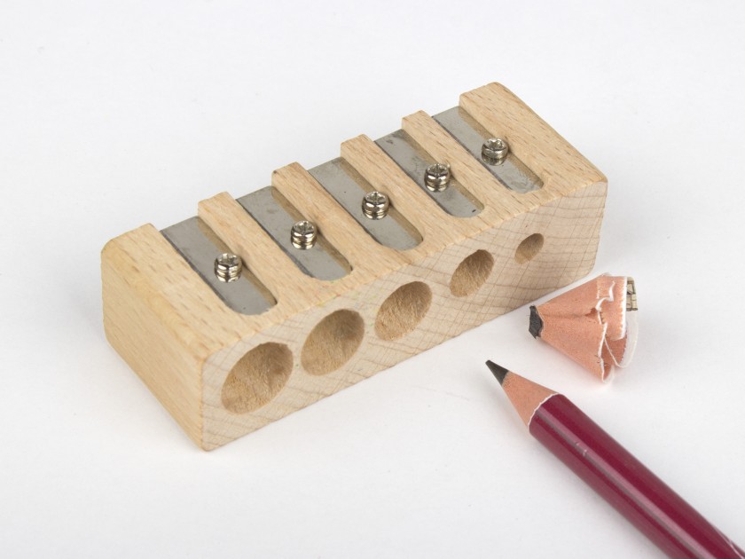 photo of a wooden pencil sharpener with 5 holes of different sizes