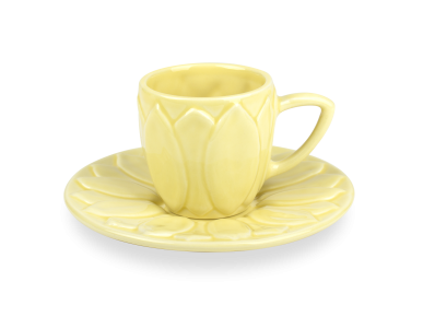 yellow glazed ceramic coffee cup on a sunflower-shaped saucer
