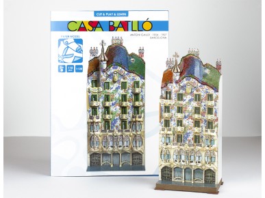 paper model of the casa batlló next to its packaging box