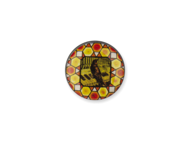 round magnet with a picture of a stained glass window showing a blackbird on an organ