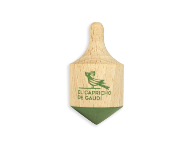 wooden spinning top with El Capricho de Gaudí logo printed on it