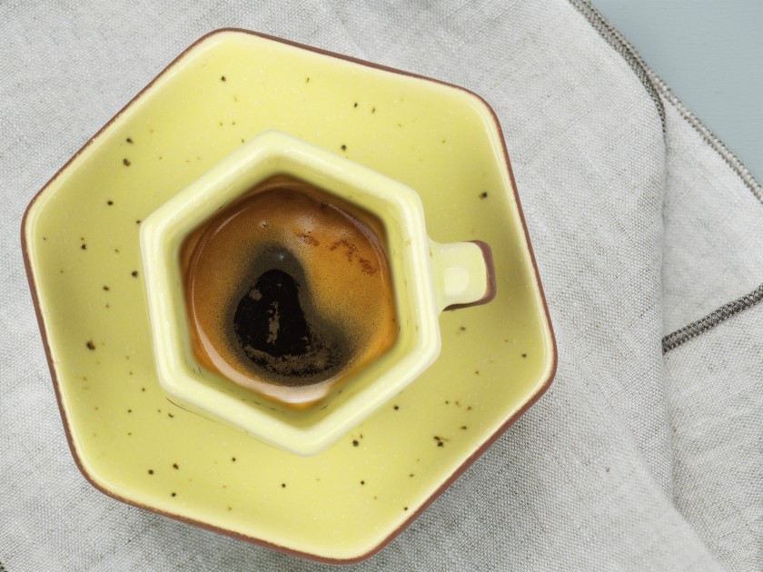 yellow enamelled coffee cup and saucer