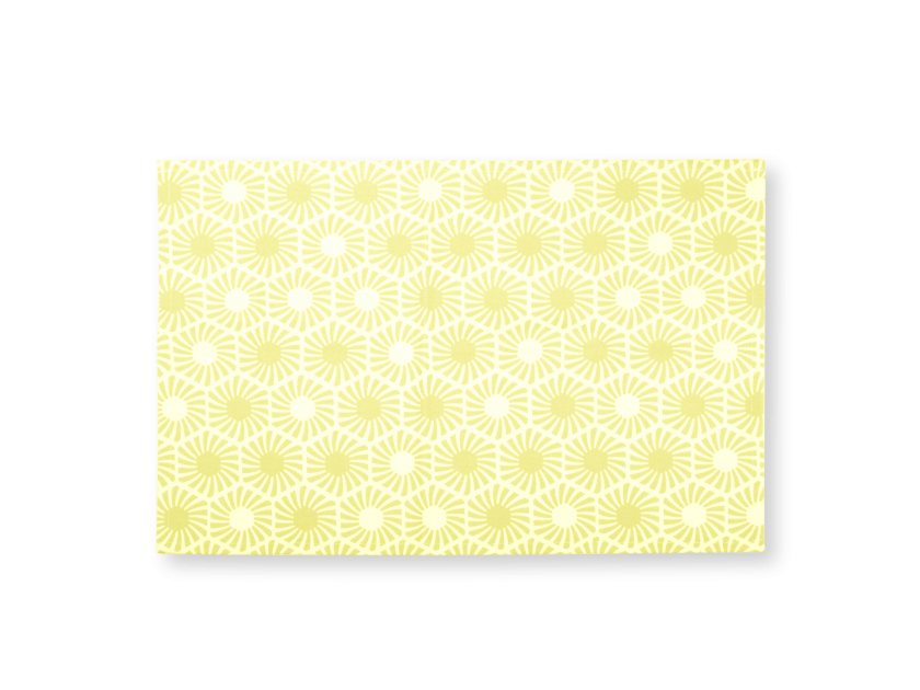 yellow placemat with printed hexagonal patterns