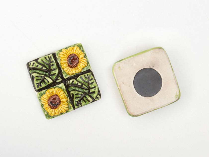 glazed ceramic magnet featuring flowers and sunflower leaves