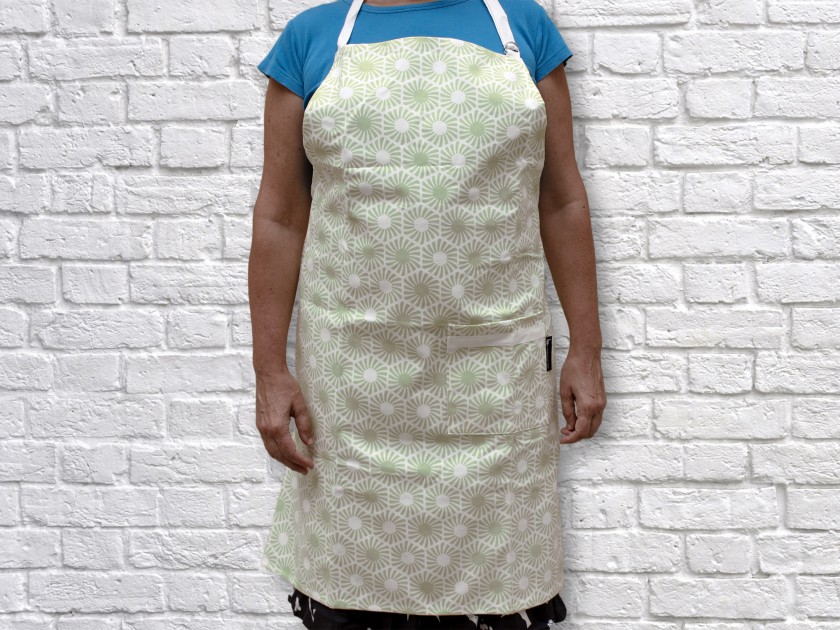 green apron with printed hexagonal patterns