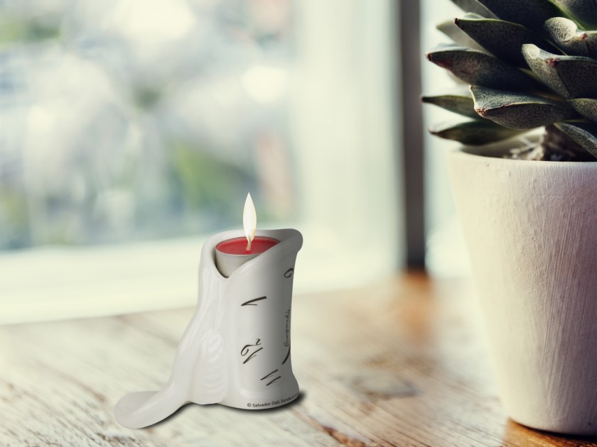 Black and white enamelled ceramic candle holder with a candle