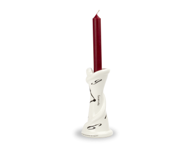 Black and white enamelled ceramic candlestick with a candle