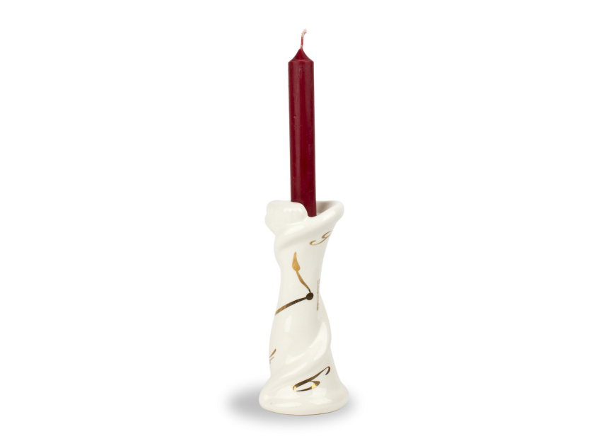 White and gold enamelled ceramic candlestick with a candle