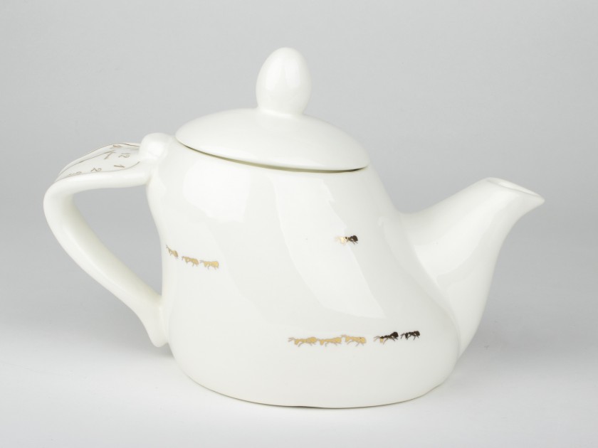 White and gold glazed ceramic teapot