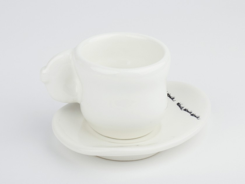 Black and white glazed ceramic coffee cup and saucer